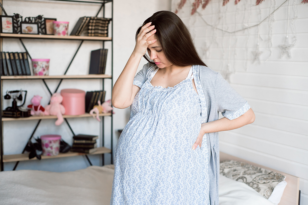 Young pregnant woman feeling bad at home